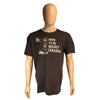 A dark brown short-sleeve t-shirt displayed on a tan mannequin against a plain white background. The shirt features a graphic of a moose wearing a red and orange hat with the text 'BORN TO BE WILDCY CANADIAN' in beige.